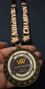 hand holding a rowhouse half marathon medal