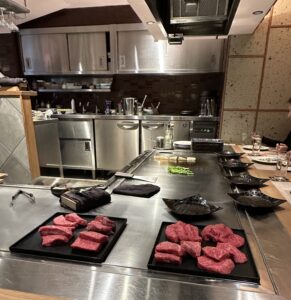 View of a kitchen grill with uncooked A5 wagyu plates 