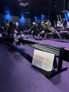 Concept 2 rowing machine with a white board that says welcome maria!