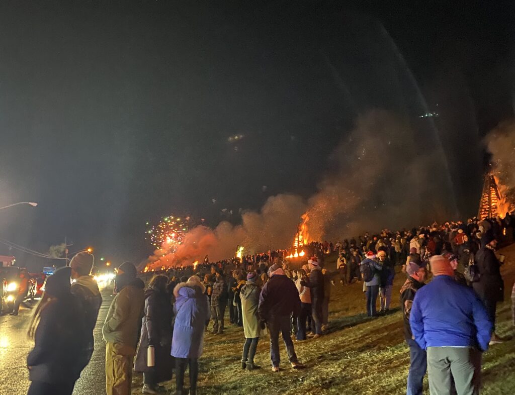 Crowd gathering to watch the fires on the levee.