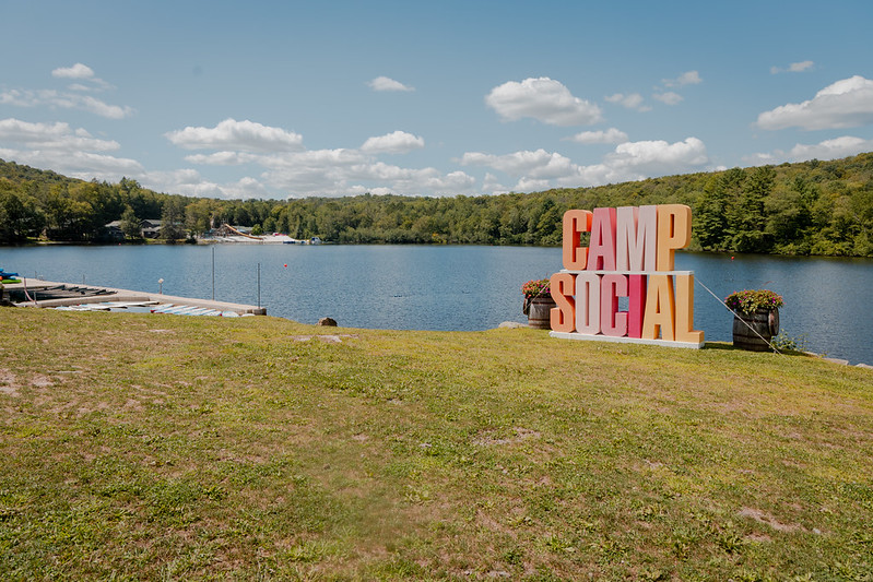 Camp Social sign with a lake in the background