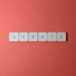 Keyboard keys arranged to spell 'update' on a vibrant red background, ideal for conveying tech concepts.